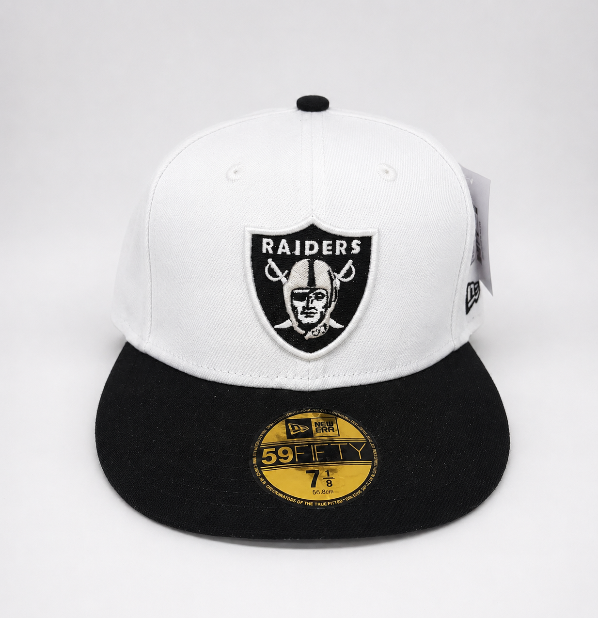 White and black cap with Raiders logo on a white background