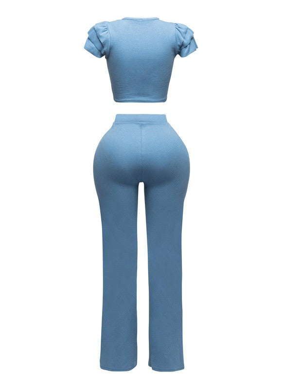 Blue outfit with a top and pants on a white background