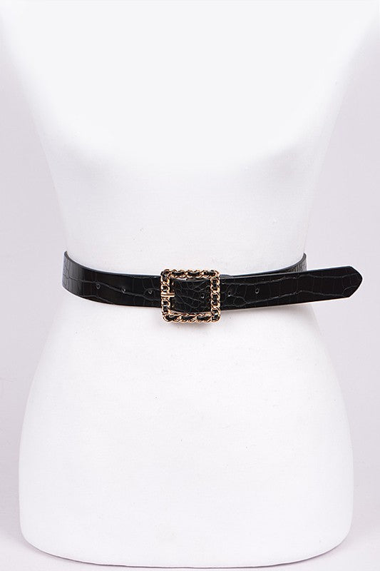 Black belt with a gold buckle on a white mannequin.