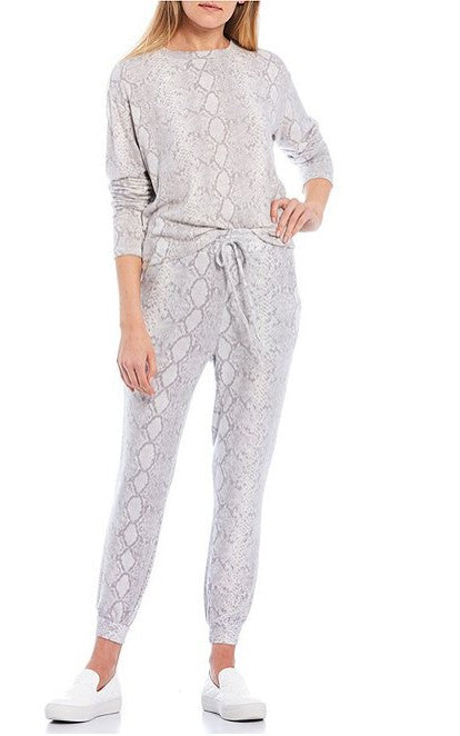 Person wearing a gray patterned loungewear set on a white background