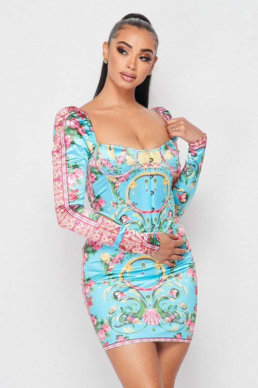 Woman wearing a colorful dress with floral and baroque patterns on a white background