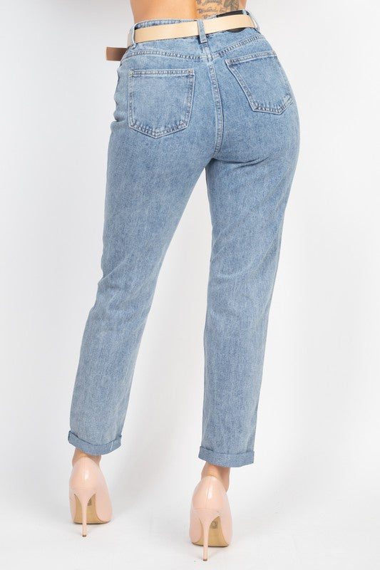 Light blue jeans worn by a person on a white background