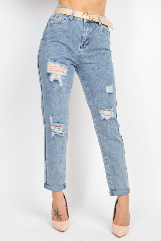 Light blue distressed jeans worn by a person on a white background