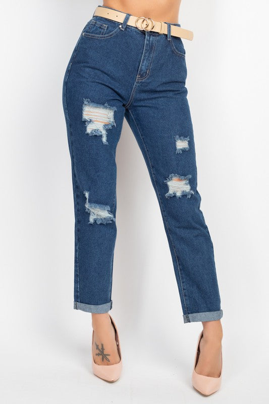 Blue jeans with distressing details on a white background