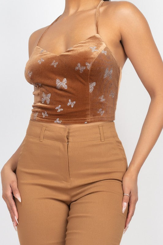 Brown top with butterfly patterns and matching pants on a white background