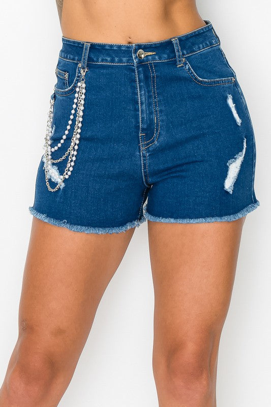 Blue denim shorts with rhinestone details on a white background