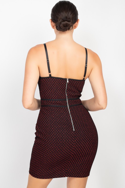 Woman wearing a patterned dress with thin straps on a white background