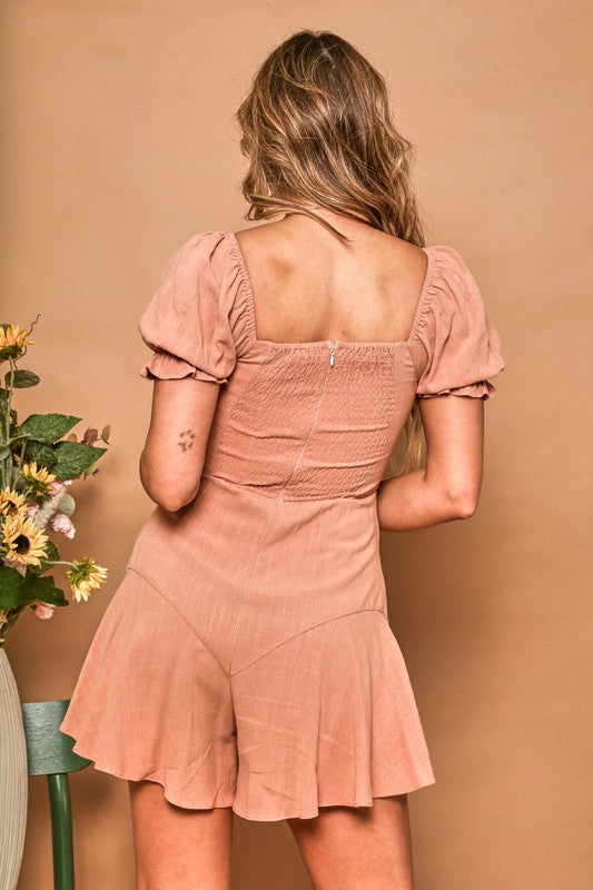 Woman wearing a pink dress against a beige background