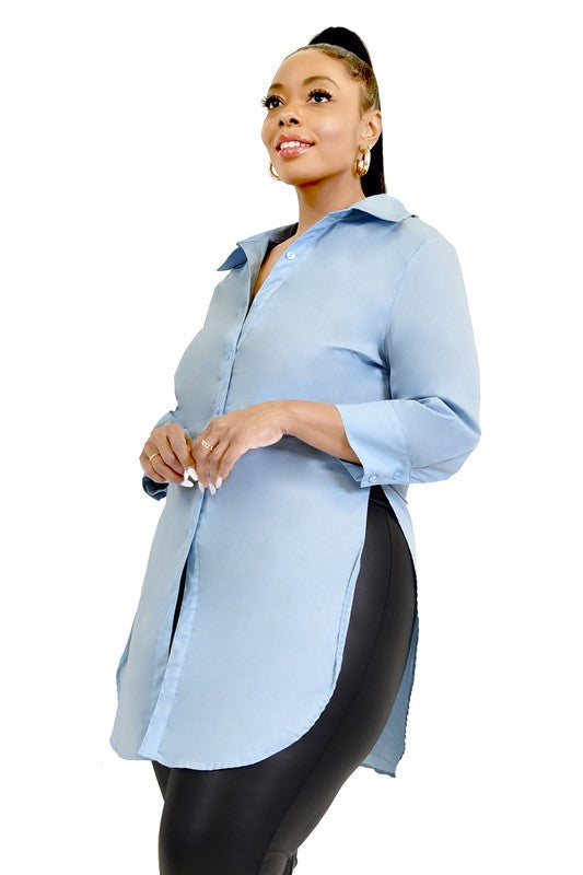 Woman wearing a light blue oversized shirt with black pants on a white background