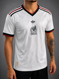 Man wearing white mexico soccer jersey.
