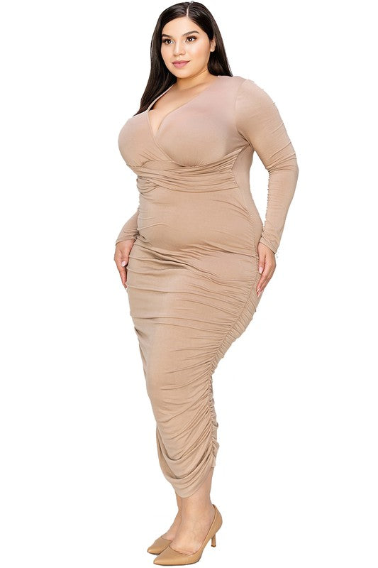 Woman wearing a beige long-sleeve dress on a white background