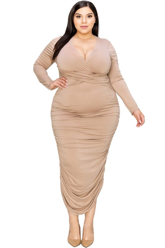 Woman wearing a beige ruched dress on a white background