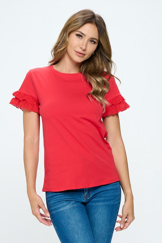 Woman wearing a red top with ruffled sleeves on a white background