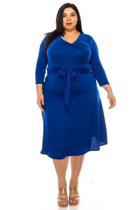 Woman wearing a blue dress with a belt on a white background