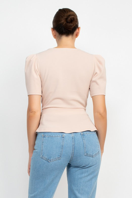 Person wearing a light pink top and blue jeans on a white background
