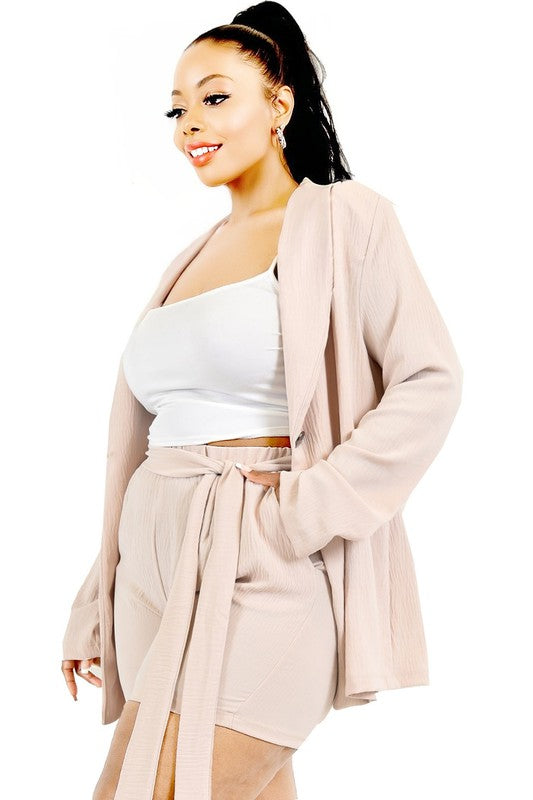 Woman wearing a beige cardigan and skirt set on a white background