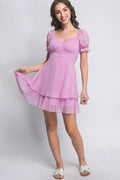 Woman wearing a pink dress on a white background