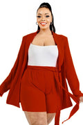Woman wearing a red outfit with a white top on a white background