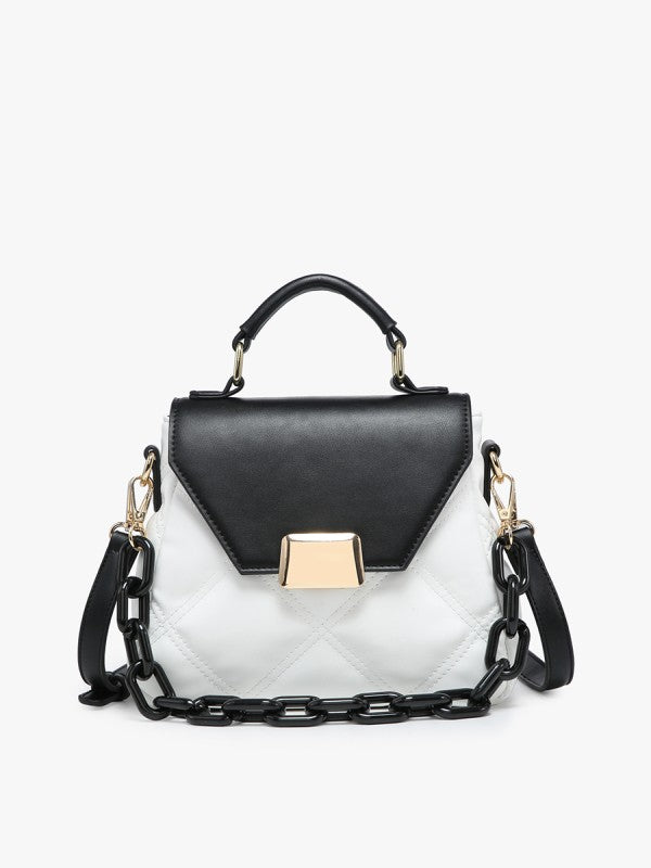 Black and white handbag with gold accents on a light gray background