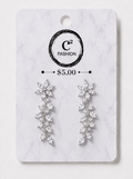 A pair of silver-toned dangle earrings with clear crystal-like leaves, displayed on a white marble-style retail card with the C² FASHION logo and a $5.00 price mark.