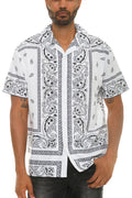 Man wearing a white shirt with black paisley pattern on a white background