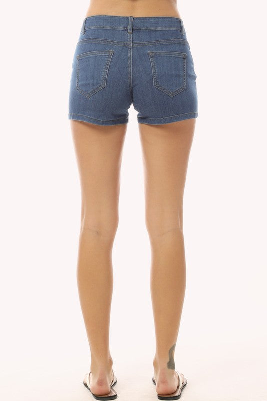 Person wearing blue denim shorts on a white background