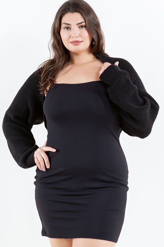 Woman wearing a black dress with a plain background