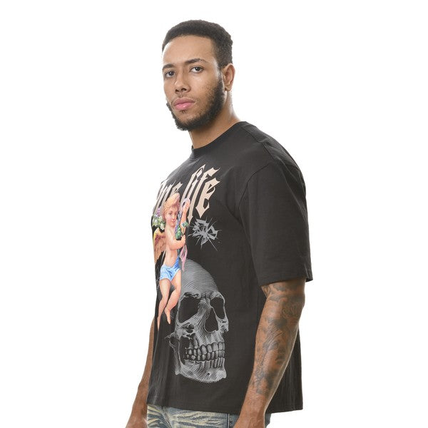 Man wearing a black graphic t-shirt with a skull design on a white background