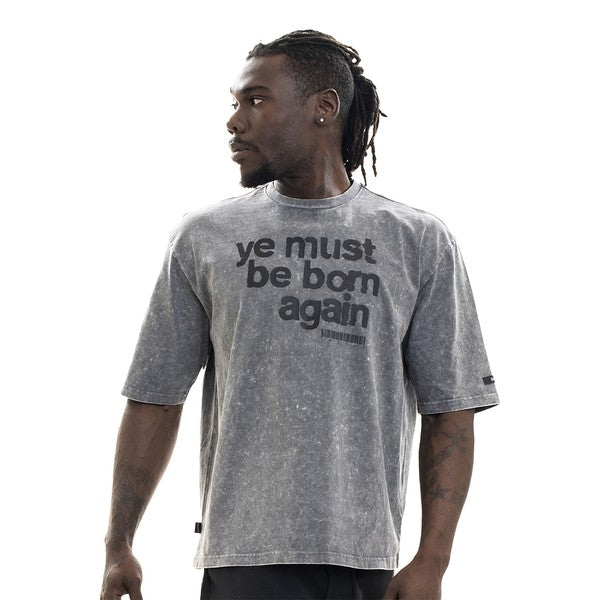 Man wearing a gray t-shirt with text on a white background