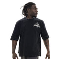 Man wearing a black t-shirt with a white logo on a white background