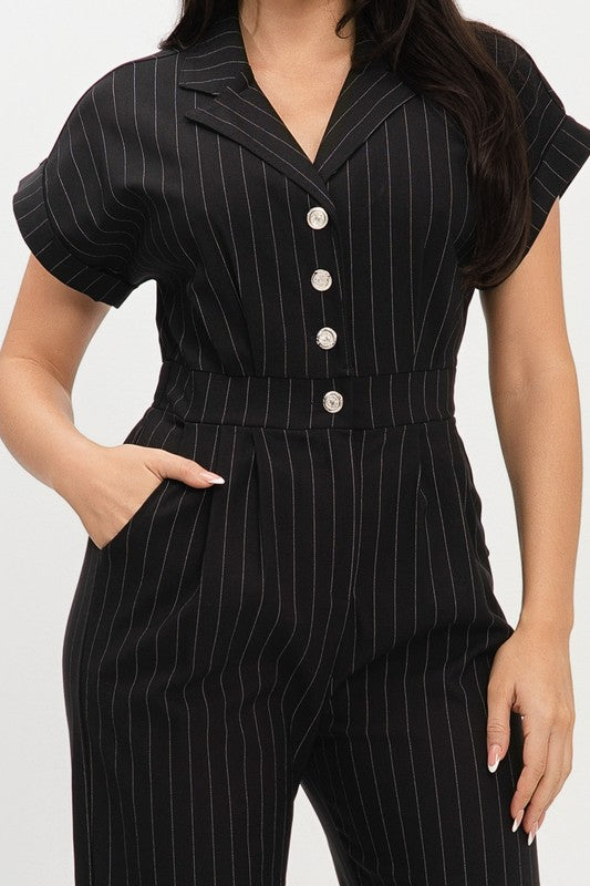 Black pinstripe jumpsuit worn by a person on a white background