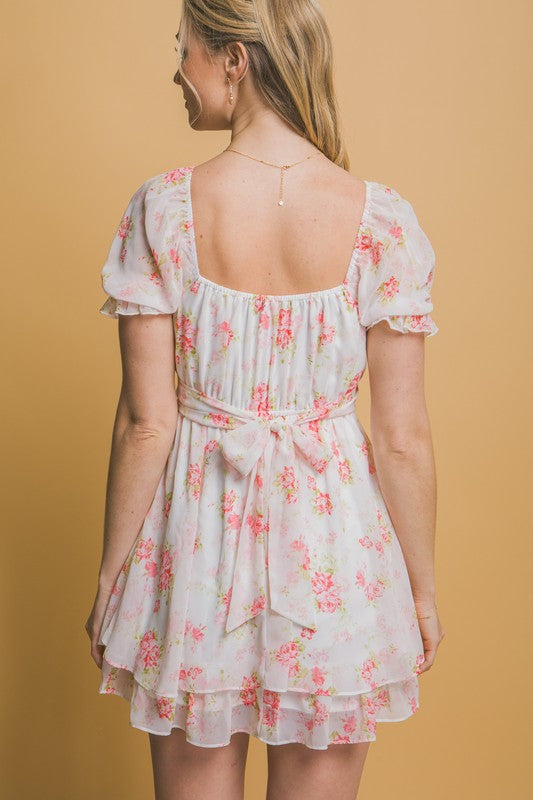 Woman wearing a floral dress against a beige background