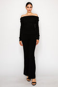 Woman wearing a black off-shoulder dress on a white background
