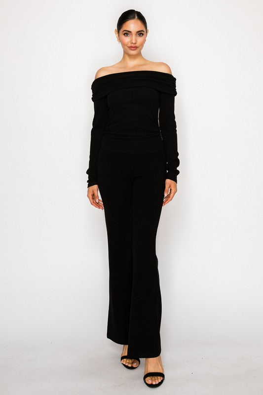 Woman wearing a black off-shoulder dress on a white background