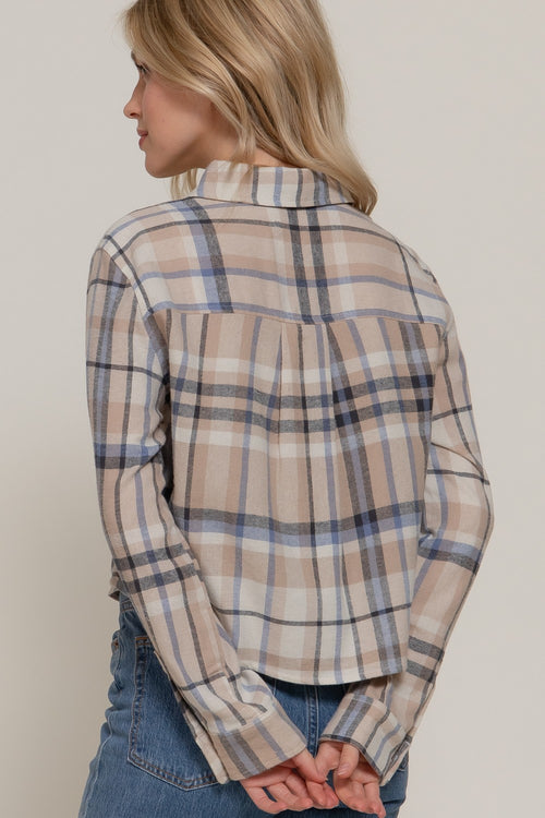 Back view of a beige plaid button-up shirt featuring blue, black, and white stripes, a folded collar, and a pleated back yoke.