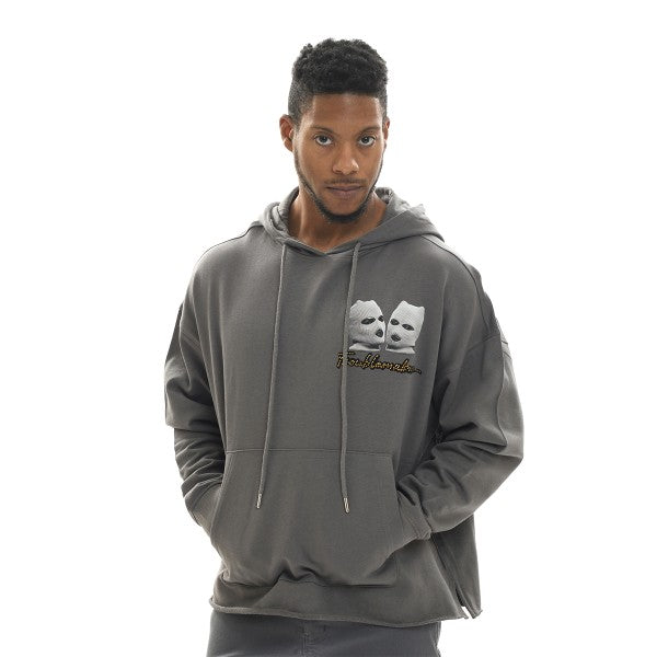 Man wearing a gray hoodie with a logo on a white background