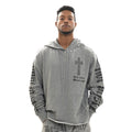 Man wearing a gray hoodie with a cross design and text on a white background