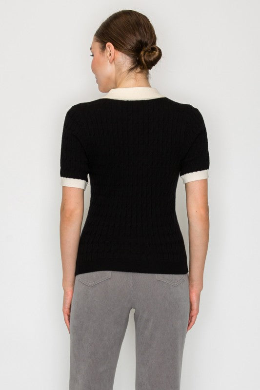 Person wearing a black t-shirt and gray pants on a white background