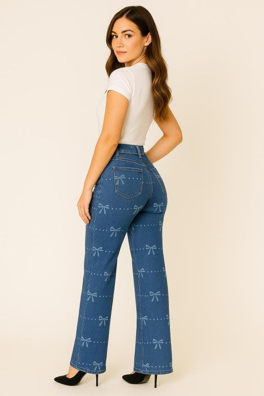 Woman wearing blue jeans with bow pattern on a beige background