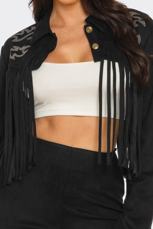 Black fringe jacket worn by a person with a white top underneath on a plain background