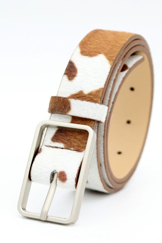 Cow print belt with a silver buckle on a white background