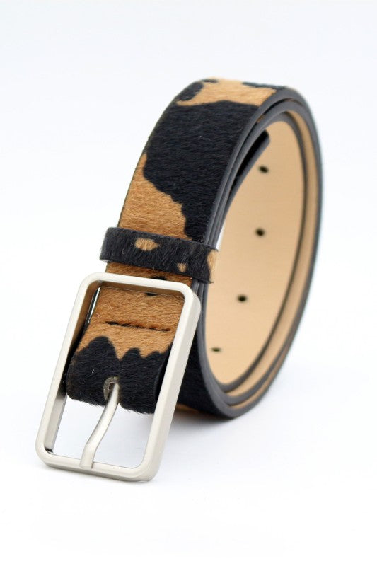 Belt with black and beige cowhide pattern on a white background