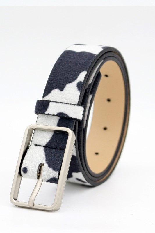 Cow print belt with a silver buckle on a white background