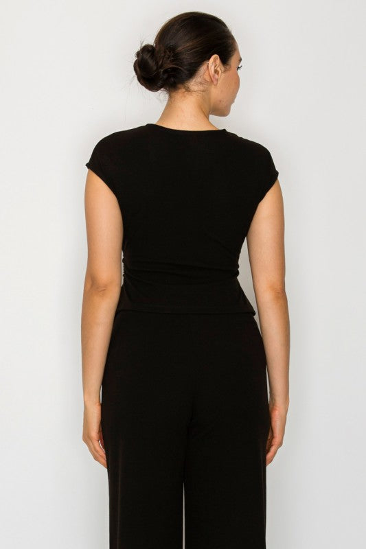 Woman wearing a black outfit against a white background