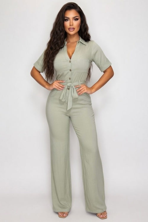 Woman wearing a green jumpsuit on a white background