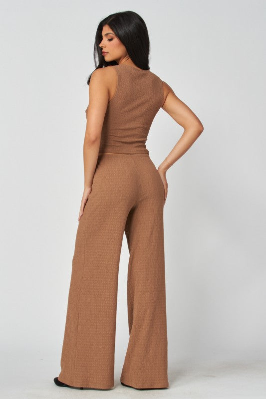 Woman wearing a brown jumpsuit on a white background