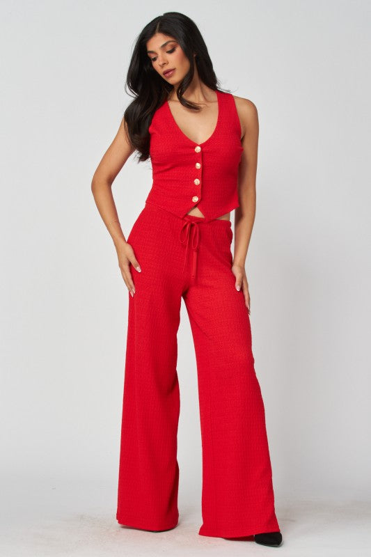 Woman wearing a red jumpsuit with a white background