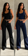 Two women modeling wide-leg cropped pants in different colors: beige, black, and navy. Each model wears a matching color tank top and stands against a textured concrete wall.