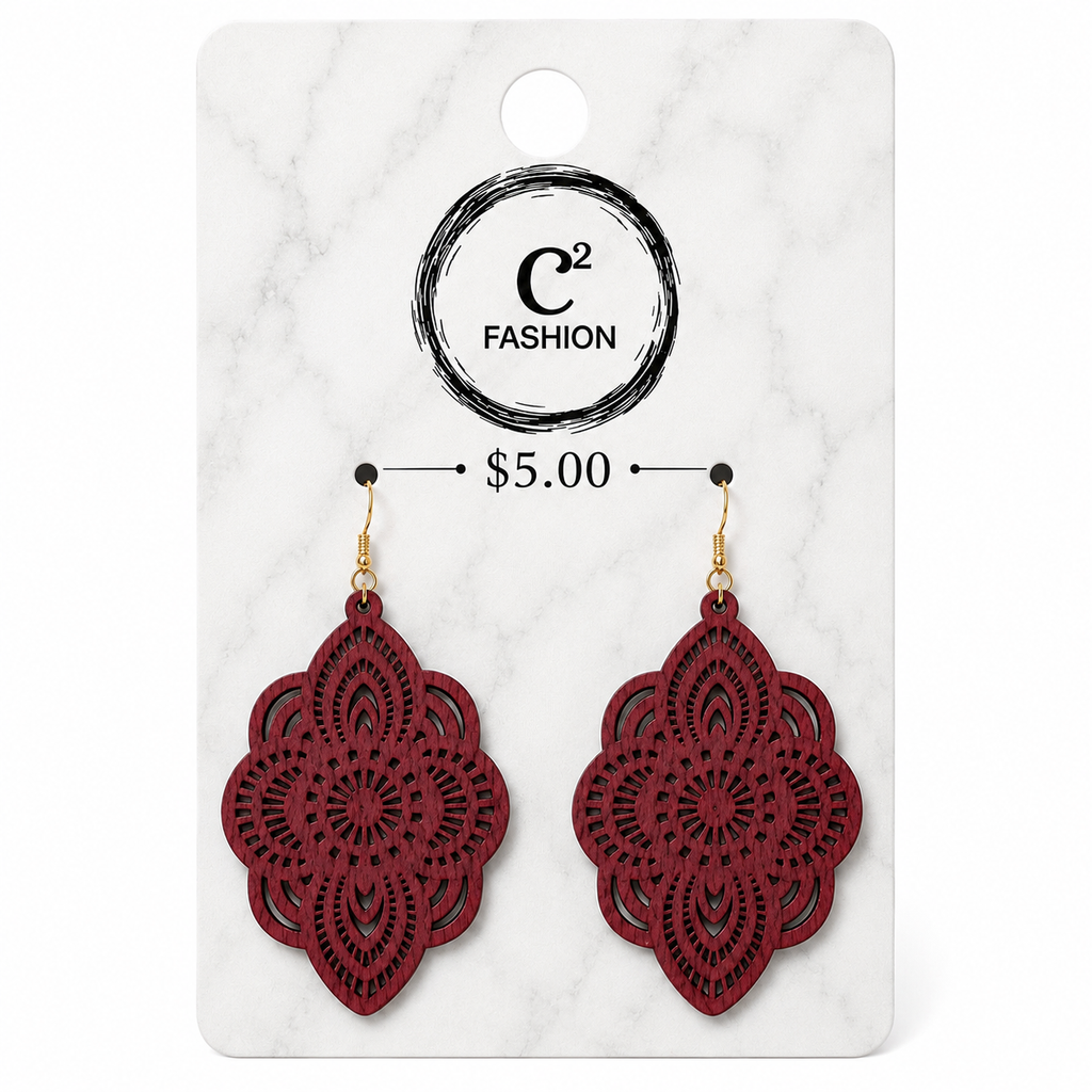 A pair of red laser-cut dangle earrings with gold hooks, displayed on a white marble-patterned retail card featuring the brand name 'C2 FASHION' and a price of '$5.00'.