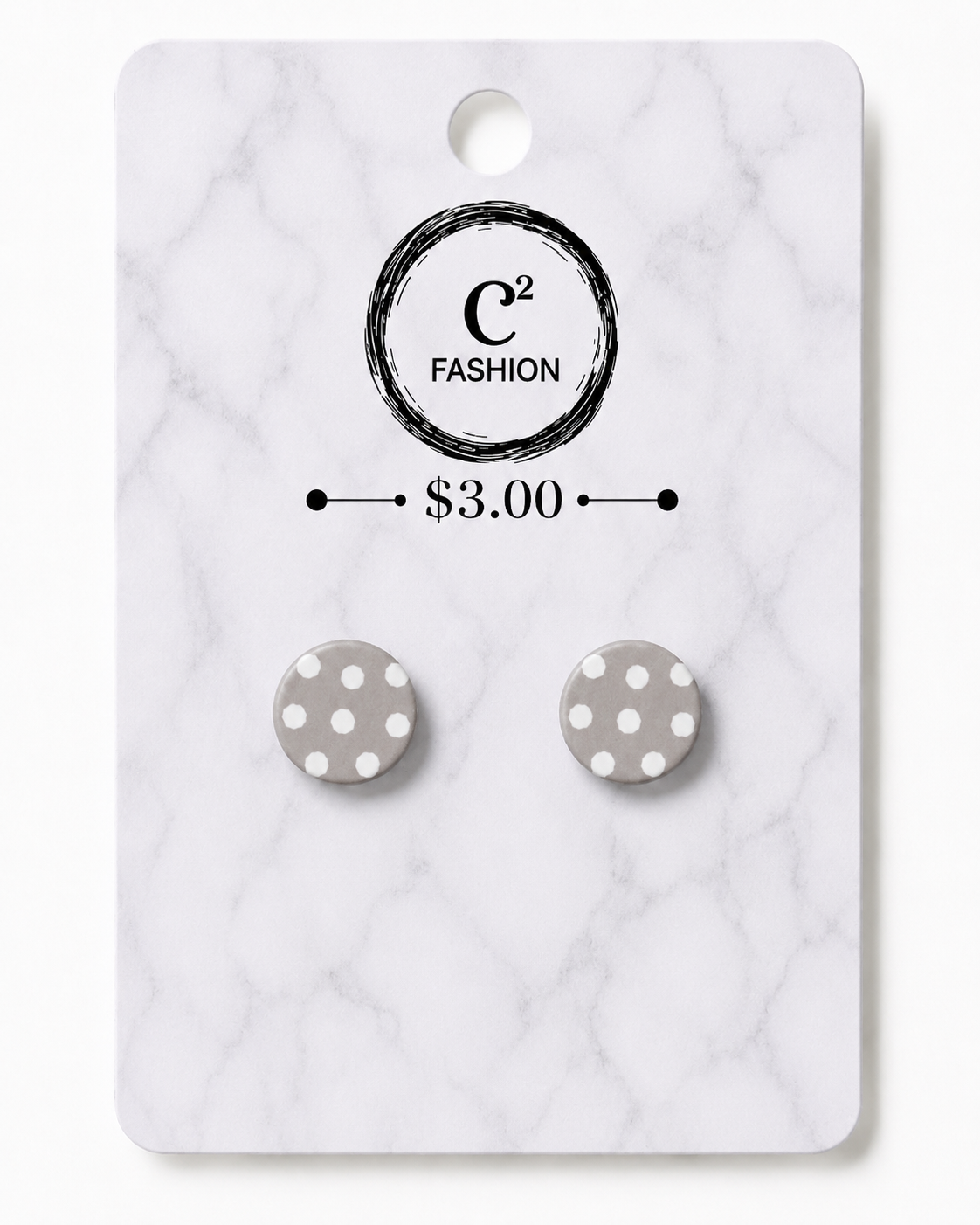 A pair of round gray and white polka dot stud earrings displayed on a white marble-patterned retail card with the brand name C2 FASHION and a $3.00 price printed on it.